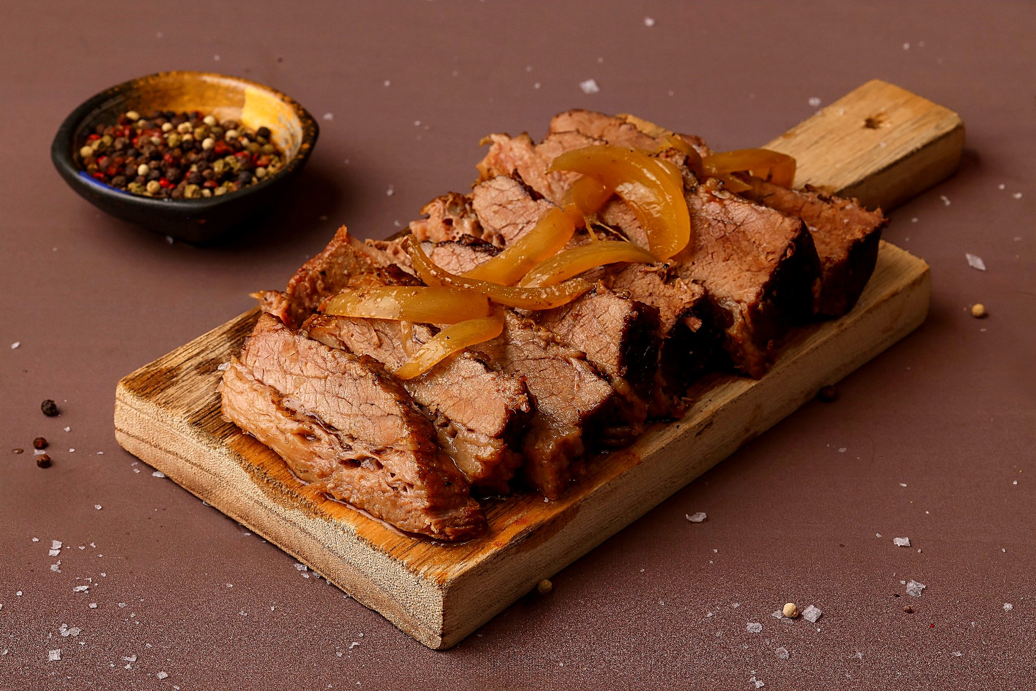 Sliced slow-roasted brisket with caramelized onions